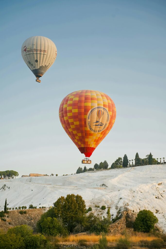 pexels-photo-19137070-19137070 Hot air balloons floating over the stunning travertines of Pamukkale, Türkiye at sunrise.
