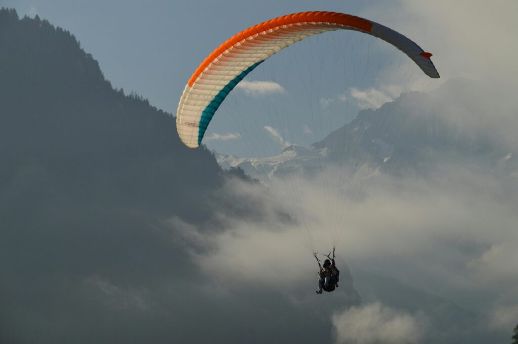 pexels-photo-30398458-30398458 Paraglider sailing through clouds above the Swiss Alps near Lucerne, capturing adventure and tranquility.